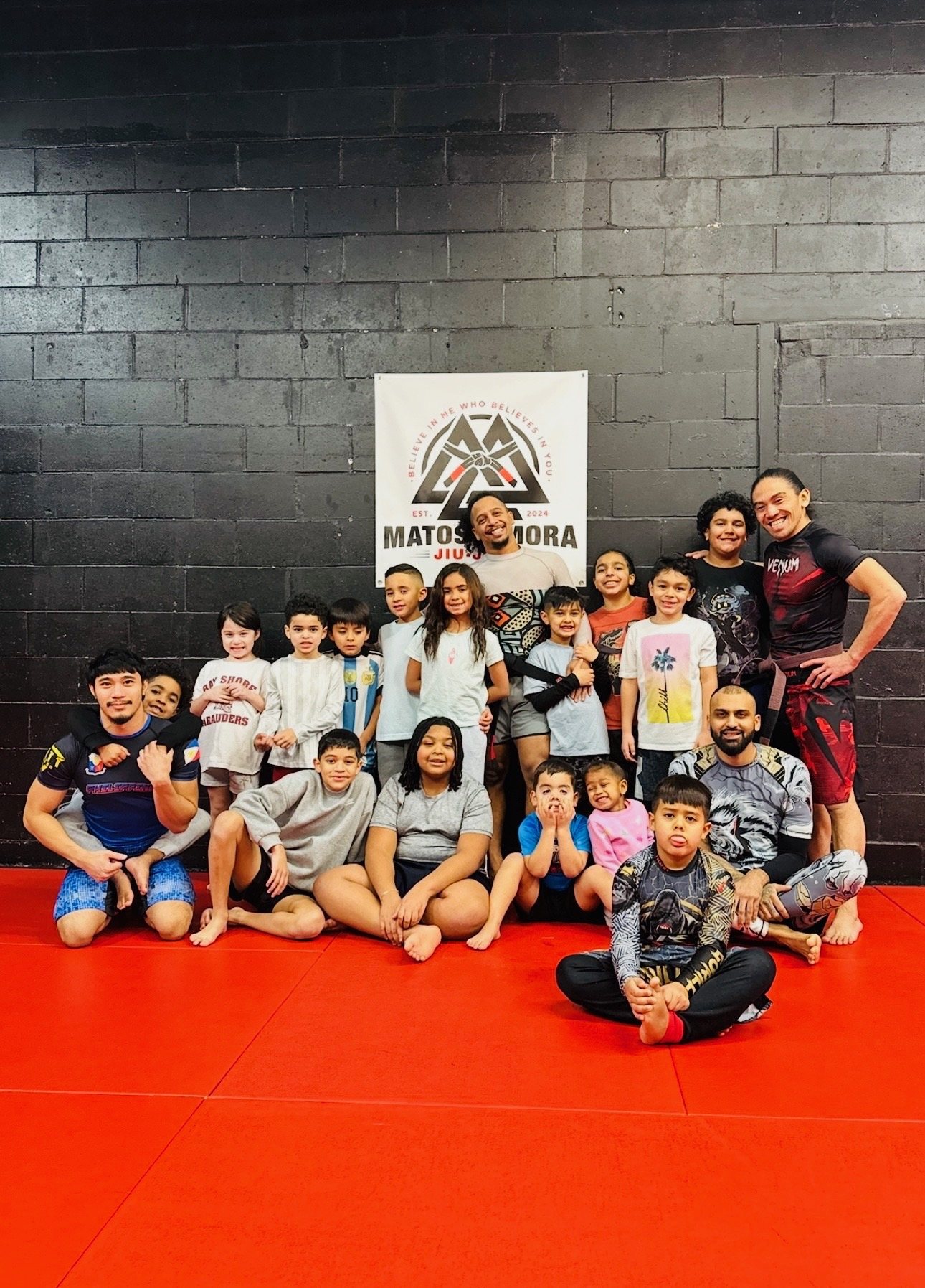 Matos & Mora kids class and coaches posing on the mats